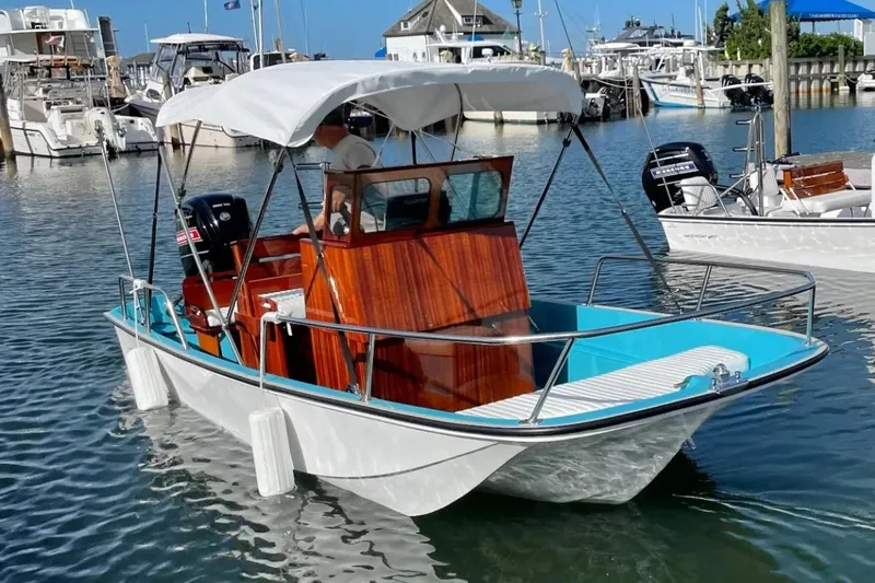 Slide: The Image of Manufacturer Provided Image: 2026 Metan Manhasset 17 boat with canopy docked in marina. - 4