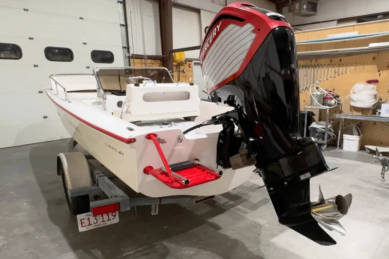 Slide: The Image of Manufacturer Provided Image: 2026 Metan Bristol 17 boat with Mercury outboard motor in a garage. - 3