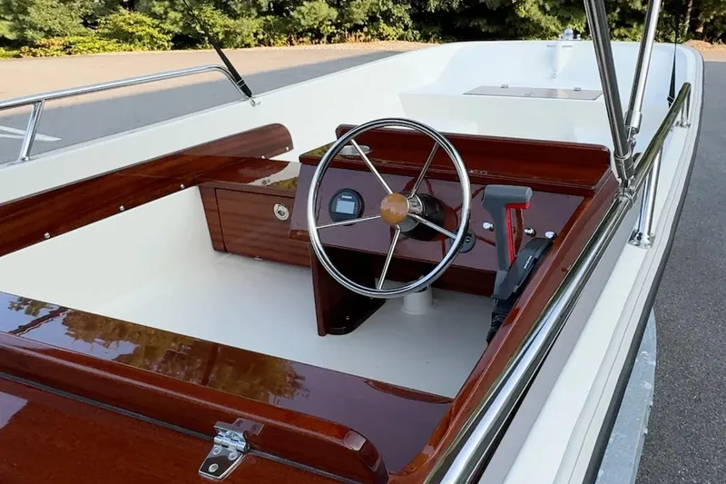 Slide: The Image of Manufacturer Provided Image: Interior of 2026 Metan Super Sport 17 boat with polished wood finish and steering wheel. - 4