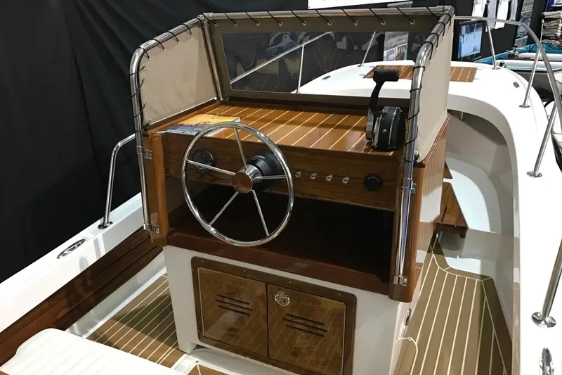Slide: The Image of Manufacturer Provided Image: 2026 Metan Pelham Bay 21 Heritage Edition boat interior with wooden steering console. - 3