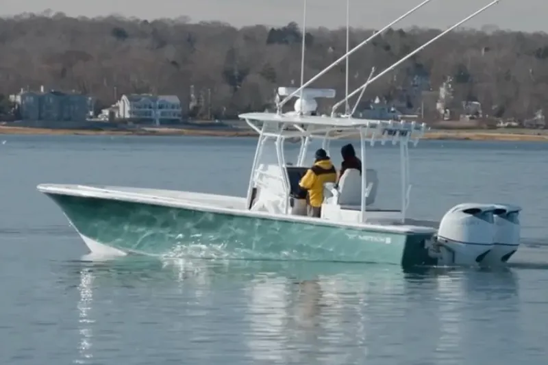 The Image of Manufacturer Provided Image: 2026 Metan Glen Cove 32 boat cruising on calm waters near a coastal town. - 1