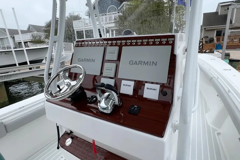 Slide: The Image of Manufacturer Provided Image: Control panel of 2026 Metan Glen Cove 32 boat with Garmin and Suzuki equipment. - 4