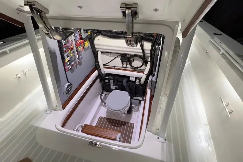 Slide: The Image of Manufacturer Provided Image: Interior view of 2026 Metan Glen Cove 32 boat, featuring a compact marine toilet. - 5