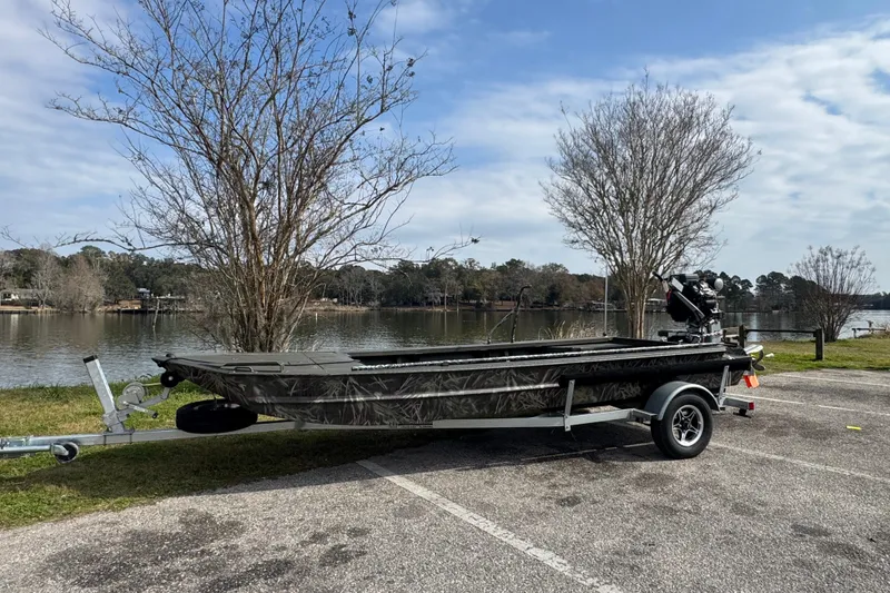 Slide: The Image of 2026 Go-Devil 18×60 Surface Drive boat on trailer by a scenic lake. - 3