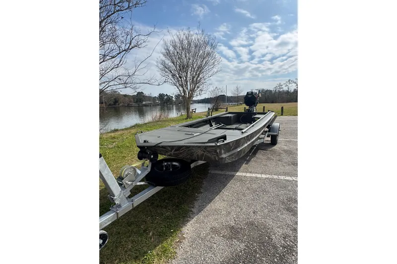 Slide: The Image of 2026 Go-Devil 18×60 Surface Drive boat on trailer by a scenic lake. - 4