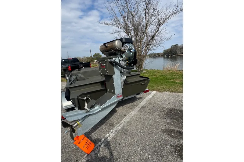 Slide: The Image of 2026 Go-Devil 18×60 Surface Drive Mud Boat on trailer by a lake. - 4