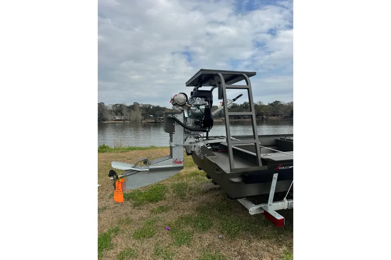 Slide: The Image of 2026 Go-Devil 18×60 Surface Drive boat on trailer by a lake. - 5