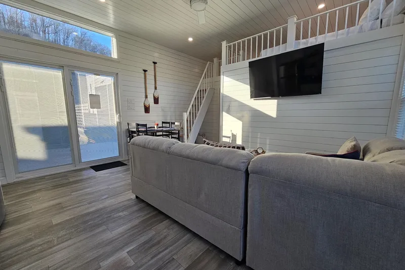 Slide: The Image of Modern 2025 houseboat interior with loft, large windows, and cozy seating area. - 10