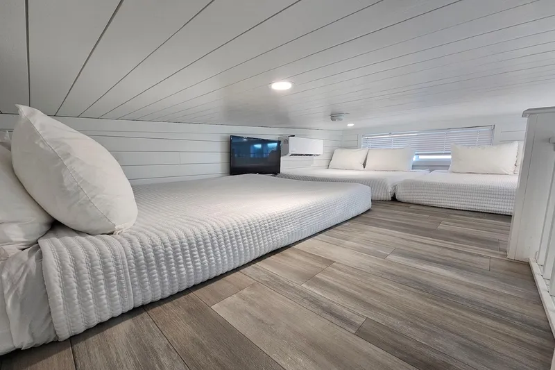 Slide: The Image of Modern 2025 houseboat interior with cozy beds, wood flooring, and sleek design. - 20