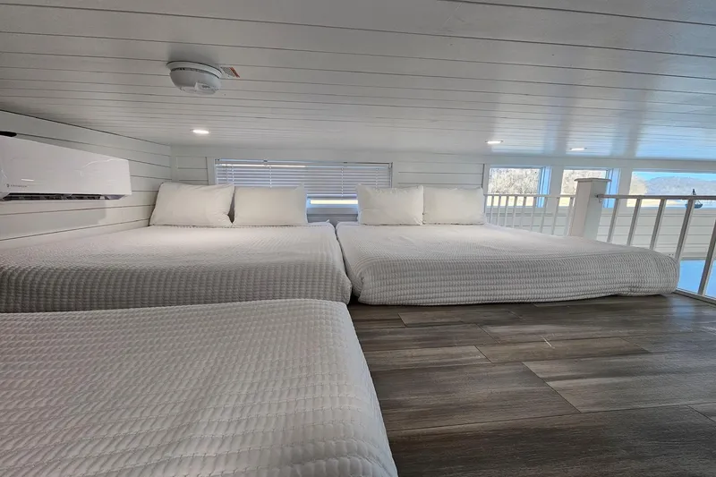Slide: The Image of Modern 2025 houseboat interior with cozy beds and wooden flooring. - 22