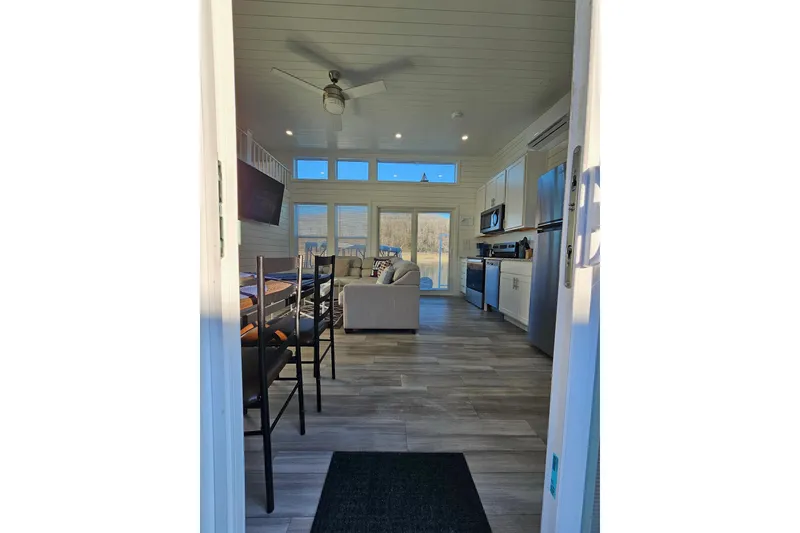 Slide: The Image of Modern 2025 houseboat interior with kitchen, dining area, and living space, featuring sleek design. - 7