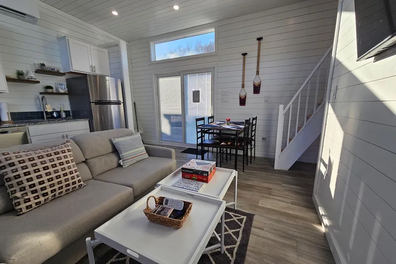 Slide: The Image of Modern 2025 houseboat interior with cozy living area, kitchen, and dining space. - 8