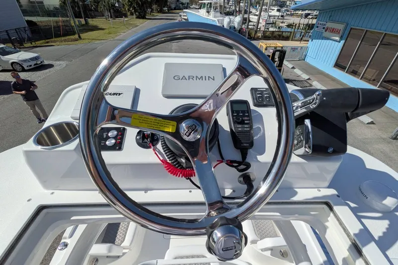 Slide: The Image of 2026 Caymas 281 HB boat dashboard with steering wheel and control panel. - 11