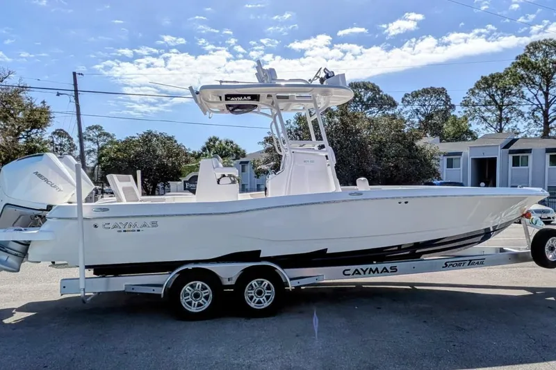 Slide: The Image of 2026 Caymas 281 HB boat with dual Mercury engines, parked on a street. - 13