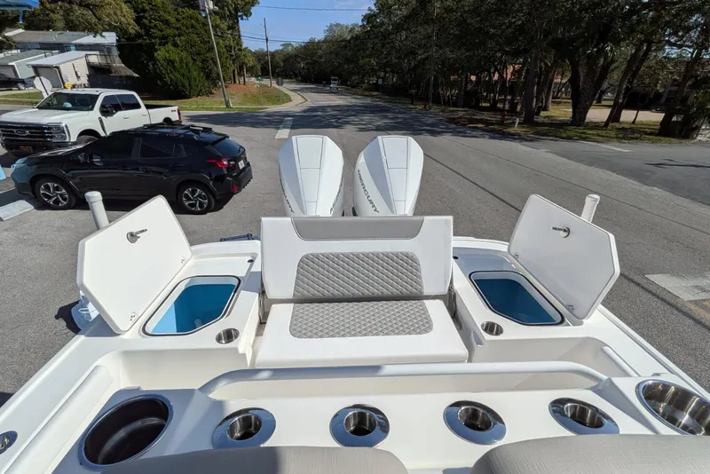 Slide: The Image of 2026 Caymas 281 HB boat with dual Mercury engines, parked on a street. - 14