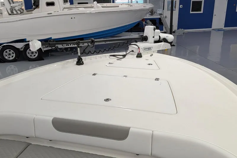 Slide: The Image of 2026 Caymas 281 HB boat in showroom, featuring Minn Kota trolling motor. - 15