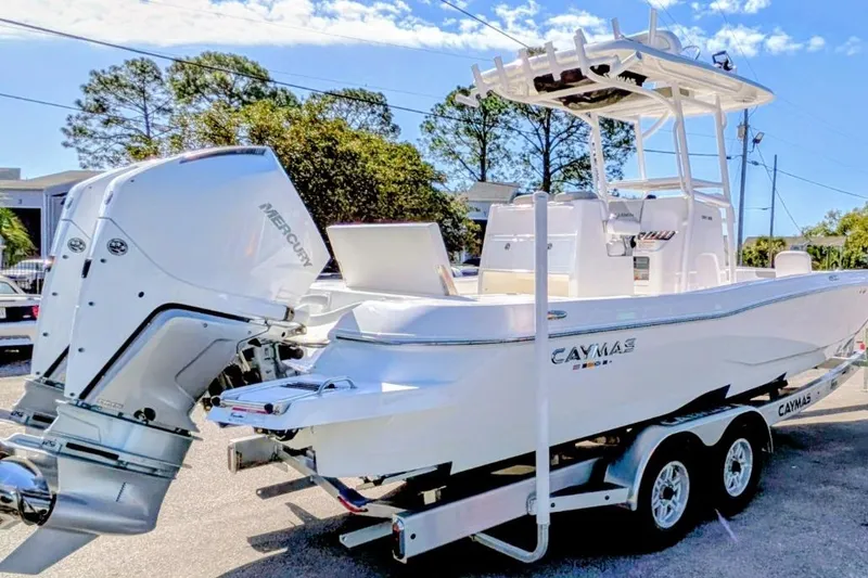Slide: The Image of 2026 Caymas 281 HB boat with dual outboard engines at a marina. - 3