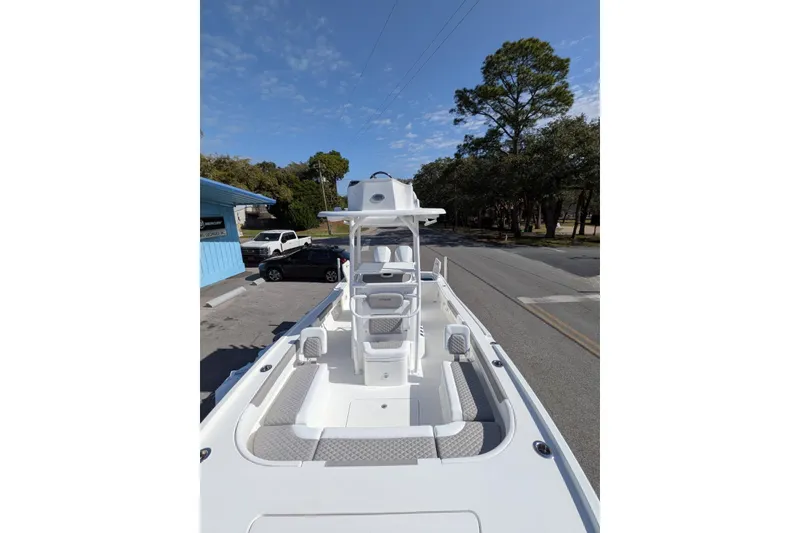 Slide: The Image of 2026 Caymas 281 HB boat on trailer, parked outdoors, clear sky background. - 5