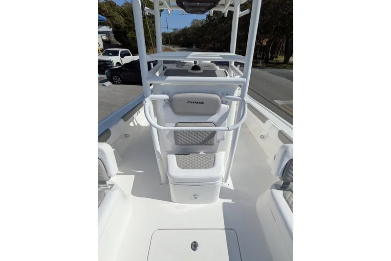 Slide: The Image of 2026 Caymas 281 HB boat with sleek design, docked near trees and a blue building. - 6