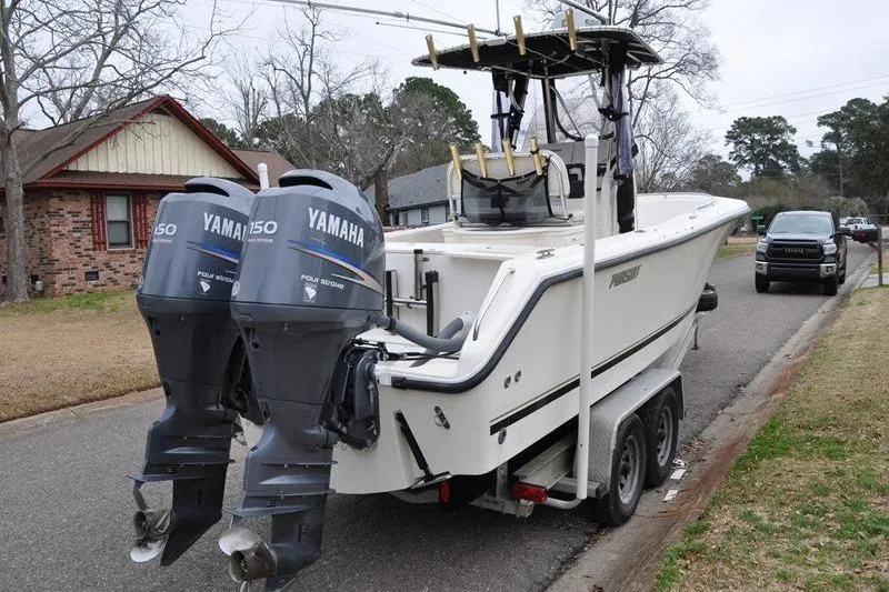 Slide: The Image of 2006 Pursuit 2570 Center Console boat with twin Yamaha 150 engines on a trailer. - 24