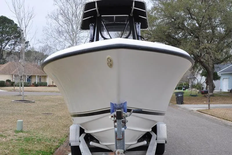 Slide: The Image of 2006 Pursuit 2570 Center Console boat on trailer in suburban neighborhood. - 27