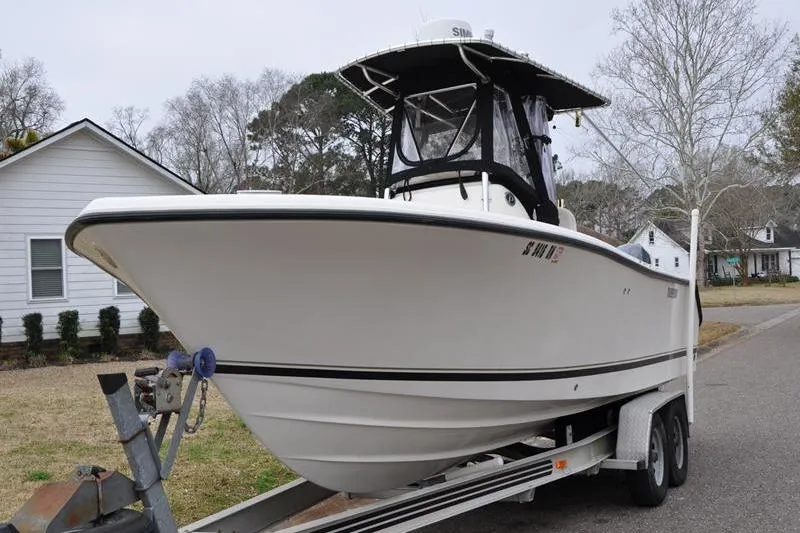 Slide: The Image of 2006 Pursuit 2570 Center Console boat on trailer, parked in residential area. - 28