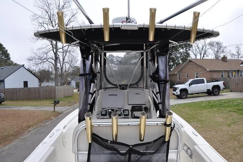 Slide: The Image of 2006 Pursuit 2570 Center Console boat with fishing rod holders and Simrad electronics. - 30