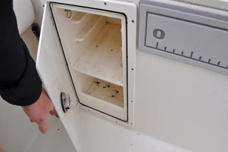 Slide: The Image of Open storage compartment on 2006 Pursuit 2570 Center Console boat. - 34