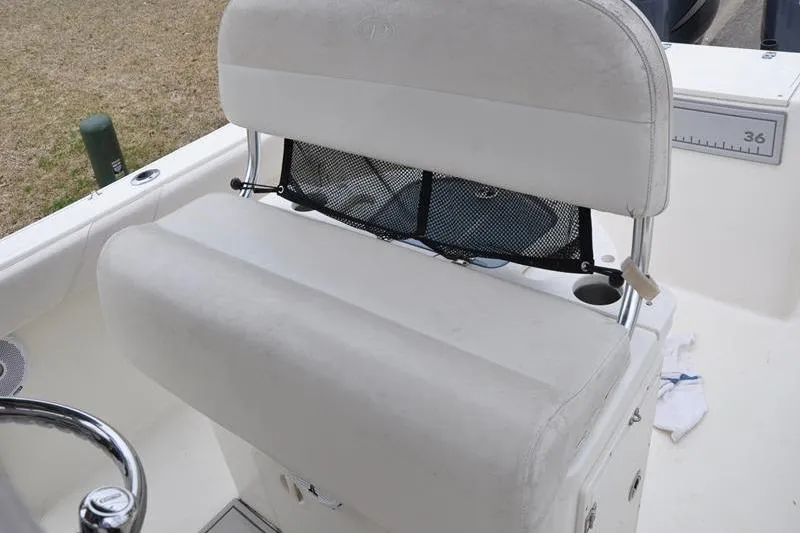 Slide: The Image of 2006 Pursuit 2570 Center Console boat seat with storage net and cup holder. - 37