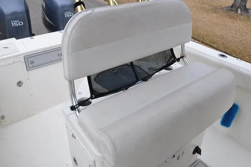 Slide: The Image of 2006 Pursuit 2570 Center Console boat seat with storage net and dual Yamaha 150 engines. - 38