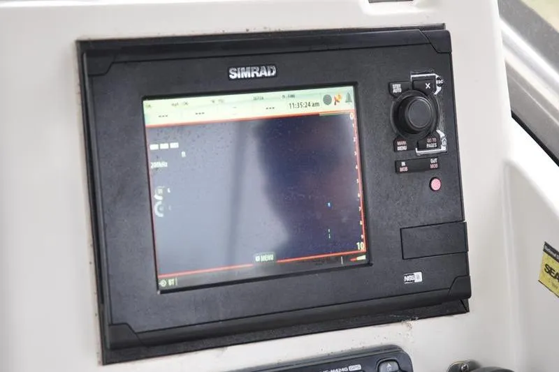 Slide: The Image of Simrad navigation system on 2006 Pursuit 2570 Center Console boat dashboard. - 42
