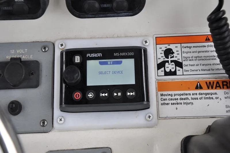 Slide: The Image of Control panel of a 2006 Pursuit 2570 Center Console boat with Fusion MS-NRX300. - 44