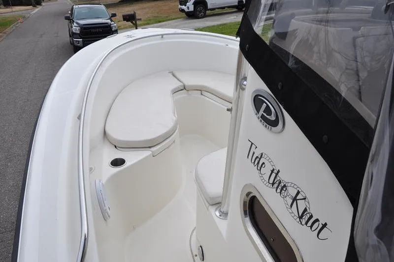 Slide: The Image of 2006 Pursuit 2570 Center Console boat with "Tide the Knot" decal, parked on street. - 48