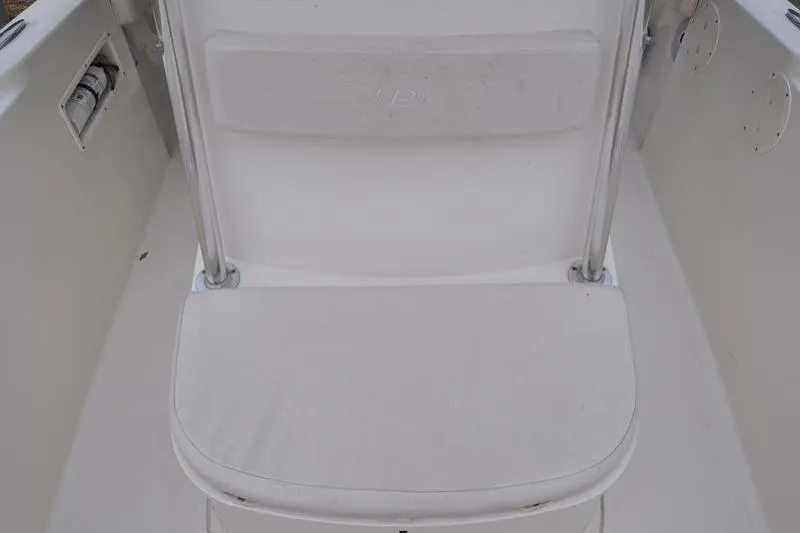 Slide: The Image of 2006 Pursuit 2570 Center Console boat seat, white upholstery, clean and well-maintained. - 51