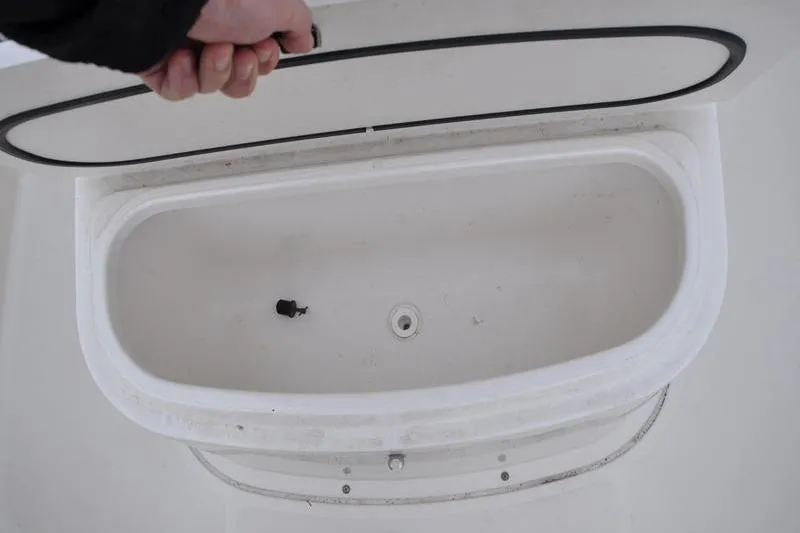 Slide: The Image of Open storage compartment on 2006 Pursuit 2570 Center Console boat. - 52