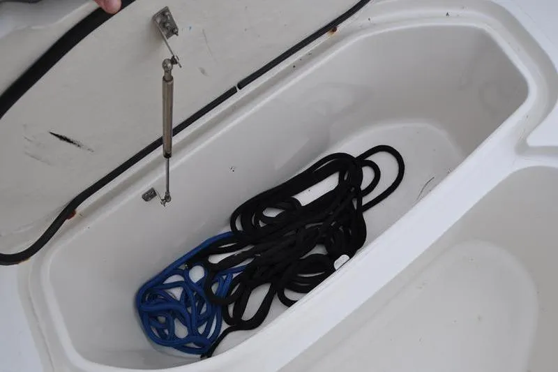 Slide: The Image of Storage compartment with ropes in a 2006 Pursuit 2570 Center Console boat. - 53
