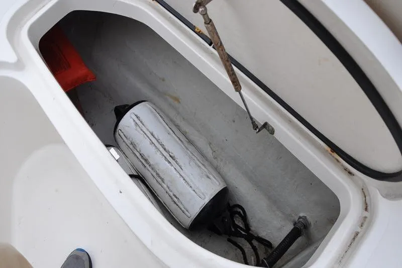 Slide: The Image of Storage compartment of 2006 Pursuit 2570 Center Console boat with fender and safety equipment. - 54