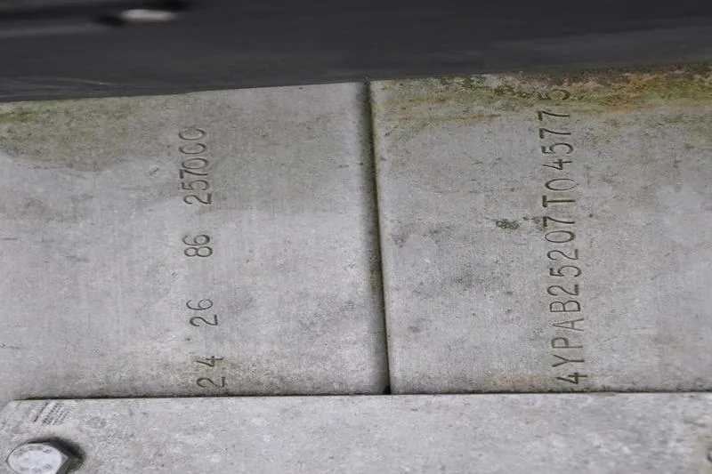 Slide: The Image of 2006 Pursuit 2570 Center Console boat hull identification number engraved on metal surface. - 59