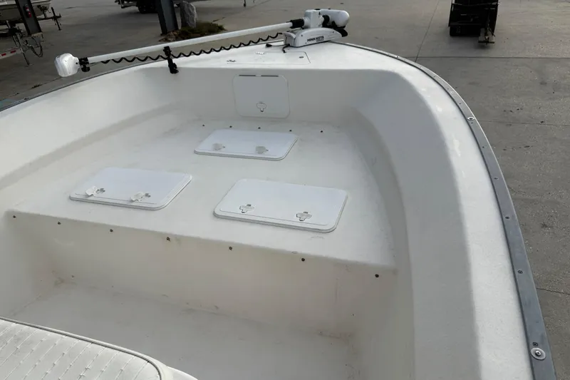Slide: The Image of 2004 Cape Horn 24 boat interior with storage compartments and trolling motor. - 10