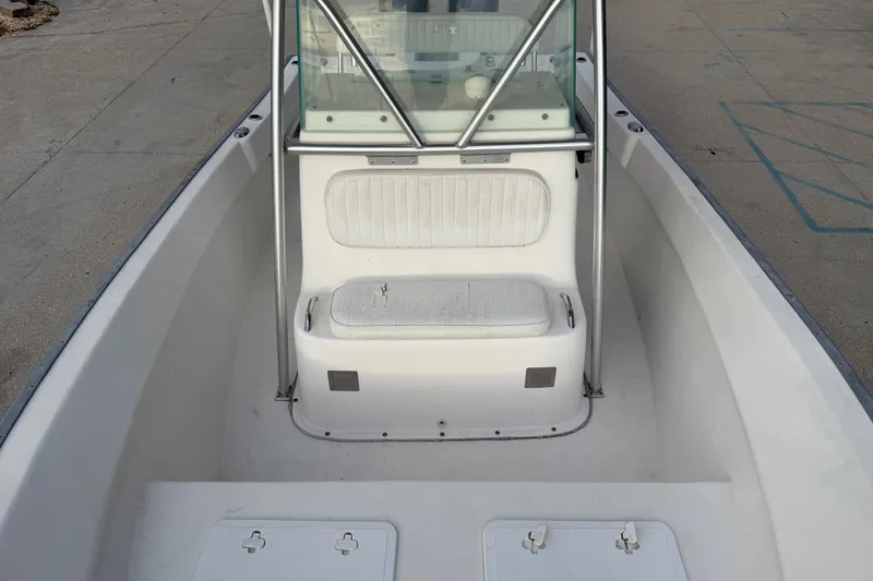 Slide: The Image of 2004 Cape Horn 24 boat interior with seating and windshield, docked on concrete surface. - 11