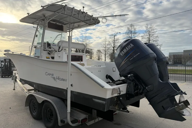Slide: The Image of 2004 Cape Horn 24 boat with Yamaha engines on a trailer, parked outdoors. - 4