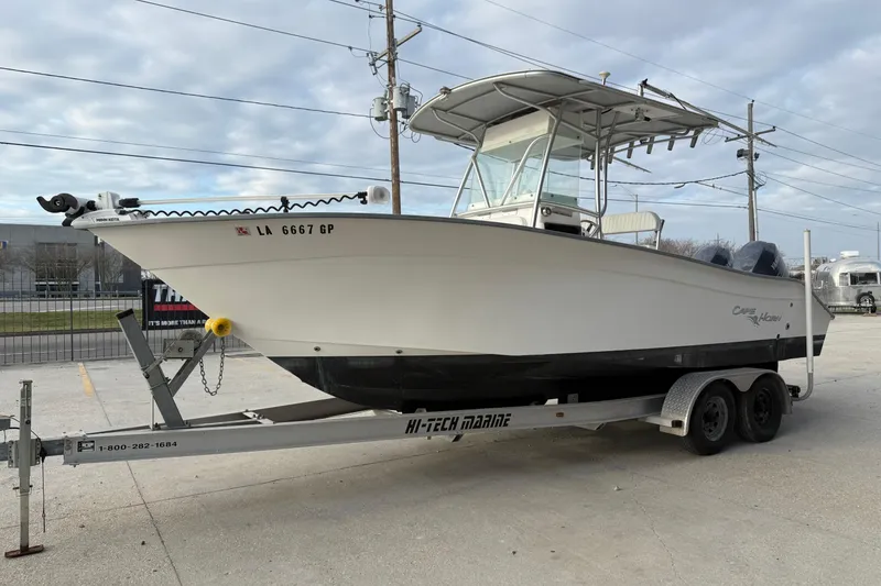 Slide: The Image of 2004 Cape Horn 24 boat on trailer, parked outdoors, overcast sky. - 6