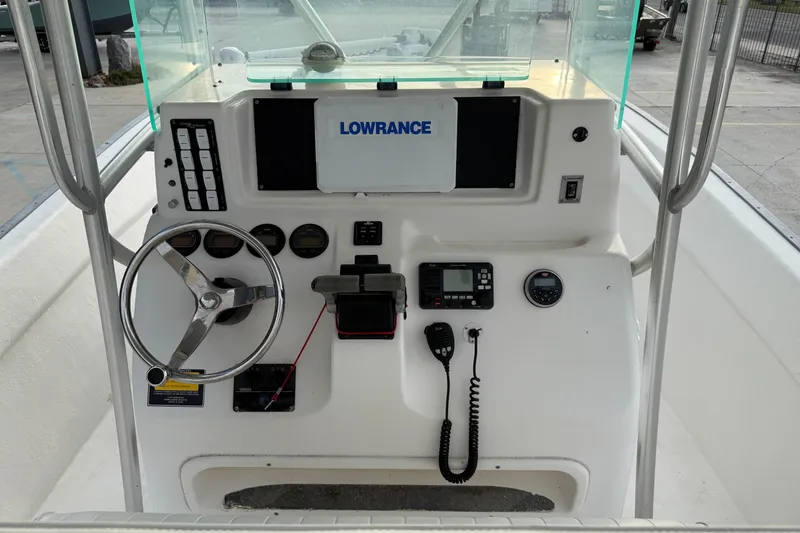 Slide: The Image of 2004 Cape Horn 24 boat console with steering wheel, gauges, and Lowrance electronics. - 9