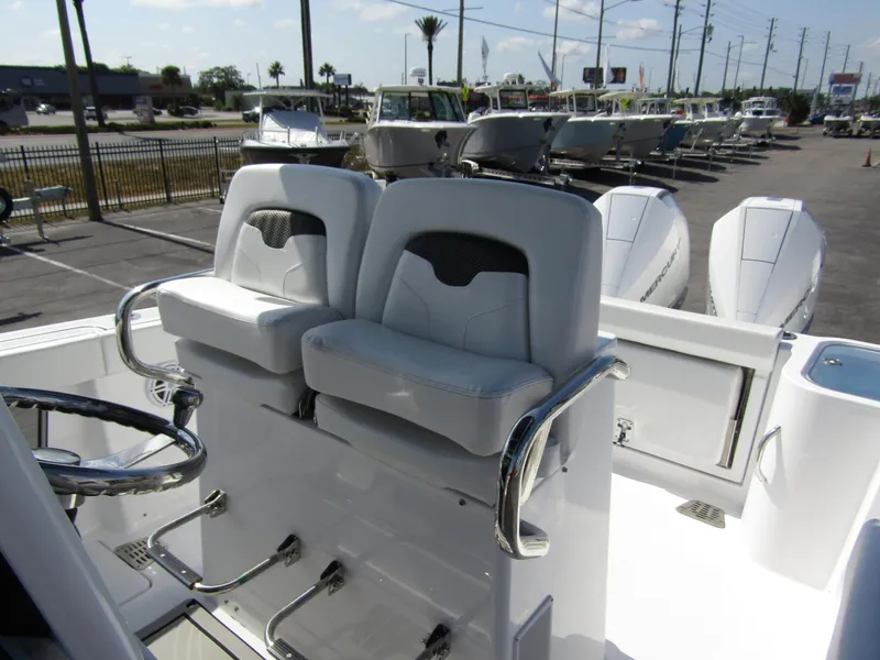 Slide: The Image of 2024 Wellcraft 263 Fisherman boat with dual captain's chairs and steering wheel. - 13