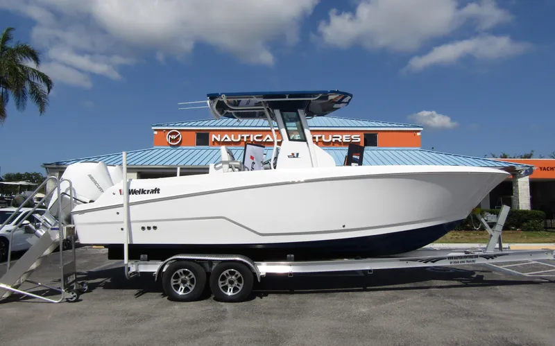 Slide: The Image of 2024 Wellcraft 263 Fisherman boat on a trailer at a dealership. - 1