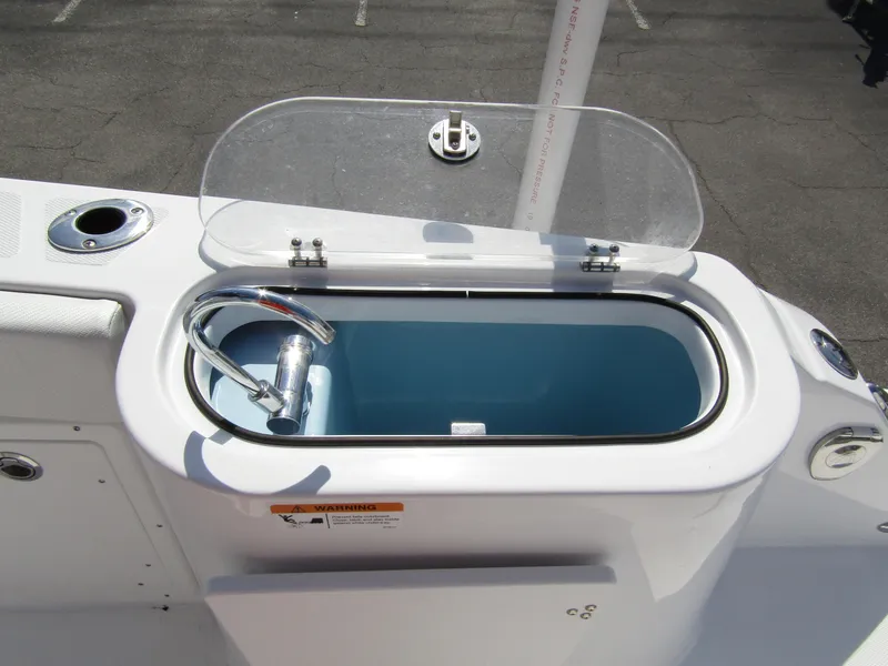 Slide: The Image of Livewell on 2024 Wellcraft 263 Fisherman boat with open lid and hose. - 31