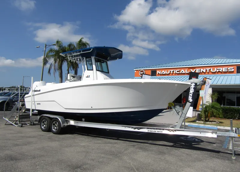 Slide: The Image of 2024 Wellcraft 263 Fisherman boat on a trailer at Nautical Ventures dealership. - 2