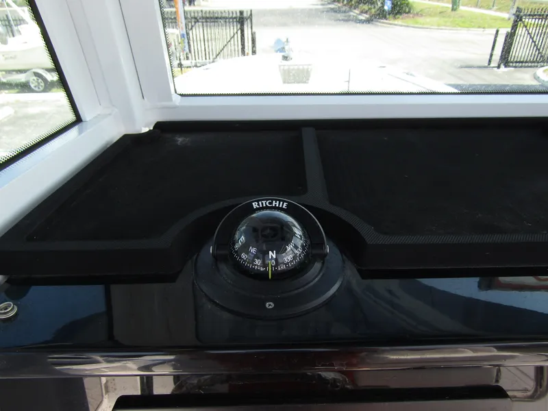 Slide: The Image of 2024 Wellcraft 263 Fisherman boat compass and dashboard. - 16