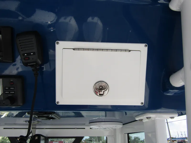 Slide: The Image of 2024 Wellcraft 263 Fisherman boat console with storage compartment and communication equipment. - 25