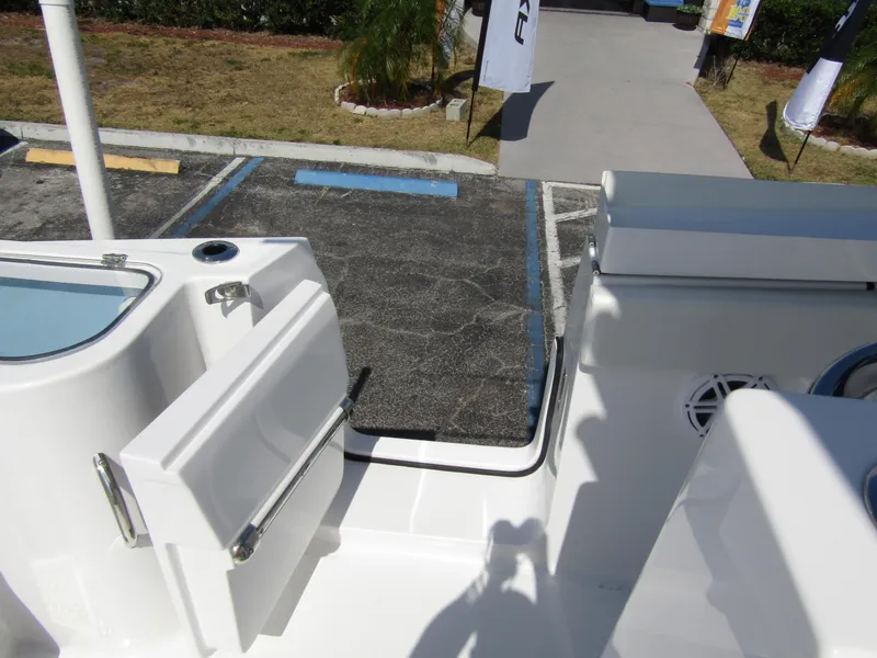 Slide: The Image of 2024 Wellcraft 263 Fisherman boat deck with open door and parking lot view. - 27